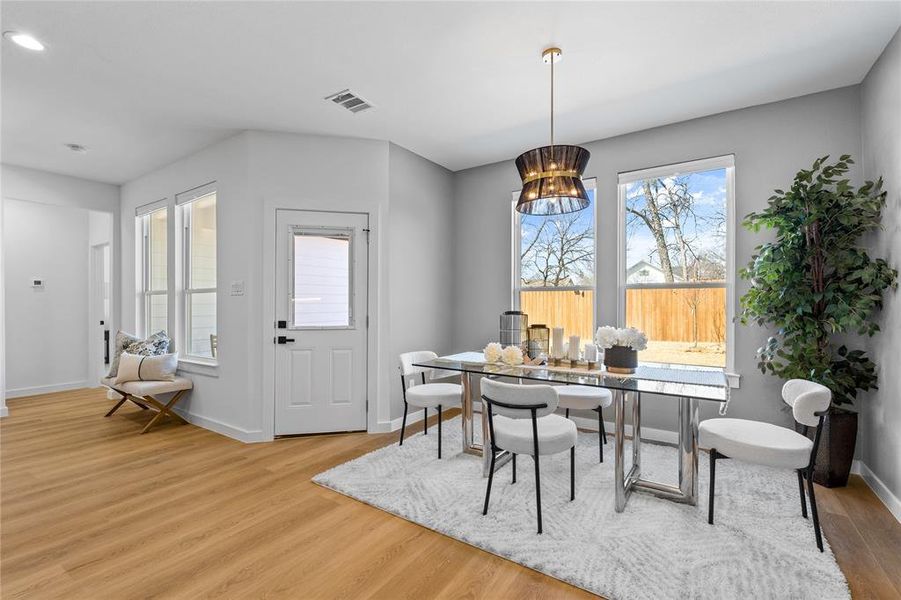 Dining area with light wood-style floors, a chandelier, and recessed lighting Dining area with light wood-style floors, a chandelier, and recessed lighting