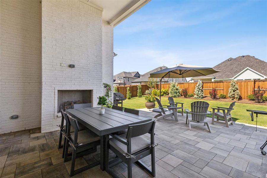 View of patio / terrace featuring an outdoor brick fireplace