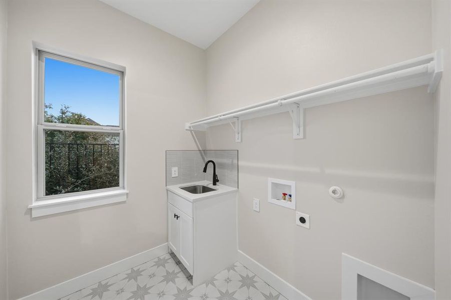 Laundry room featuring washer hookup, cabinet space, electric dryer hookup, and light floors