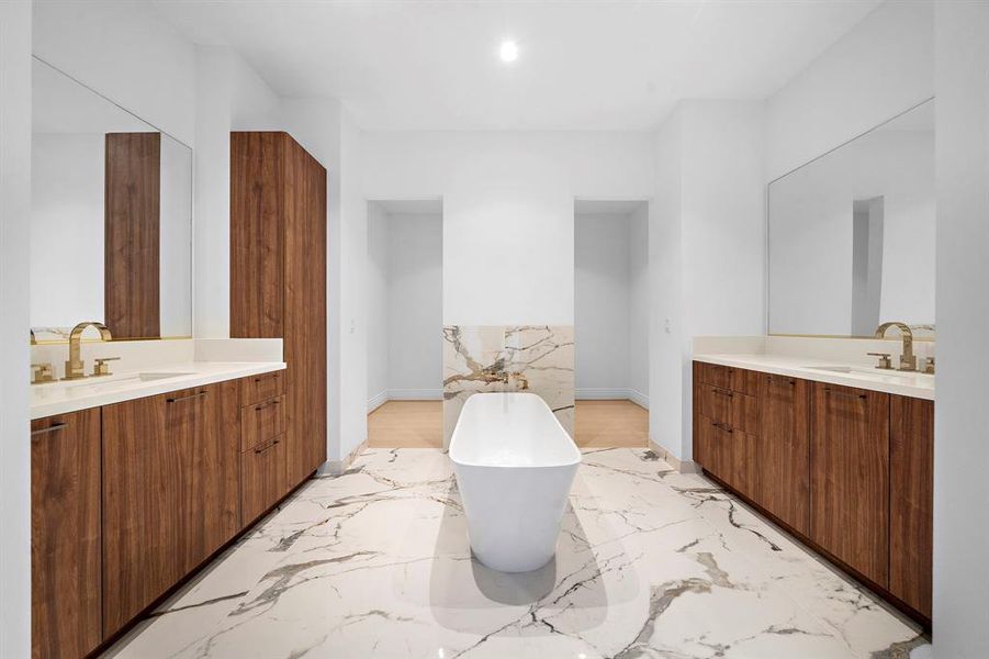 Luxurious primary bath with fabulous furniture quality cabinetry and luxury stone.