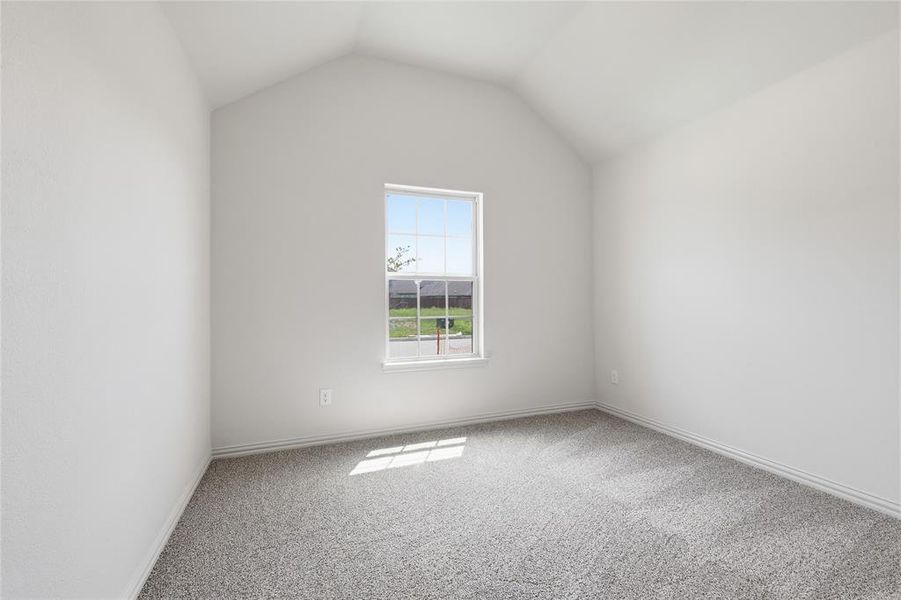 Spare room featuring carpet and baseboards