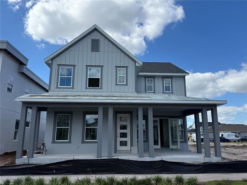 Front exterior of a new home in Laureate Park, Orlando, FL, highlighting curb appeal (Image 1). Front exterior of a new home in Laureate Park, Orlando, FL, highlighting curb appeal (Image 1).