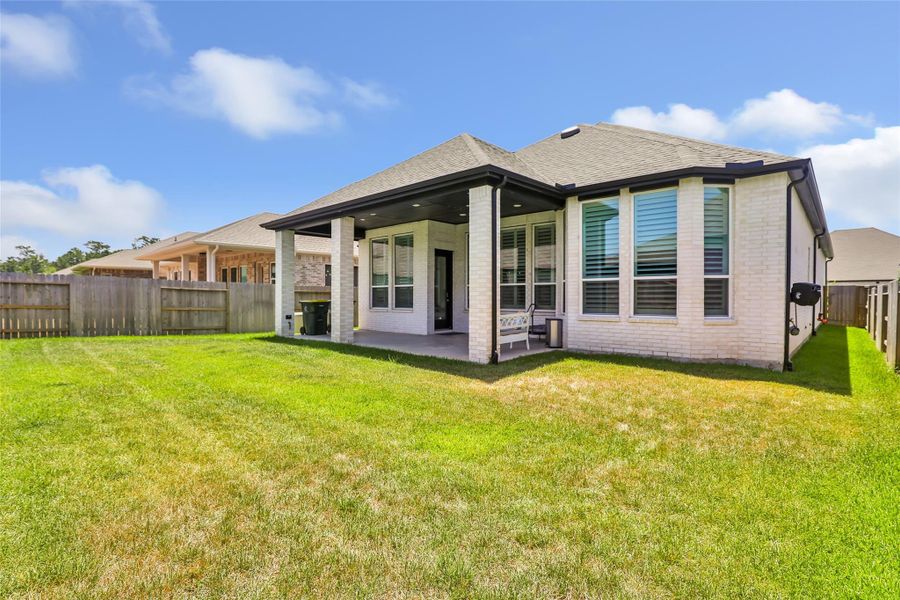 Exterior details and patio area of a home in Grand Central Park, Conroe (Image 31).