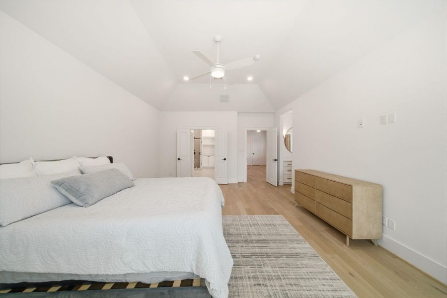 Bright and airy primary suiteoffering a versatile oversizedlayout, warm wood flooring, and athoughtfully designed privateretreat feel. (Photo of a previous build, similar finishes.)