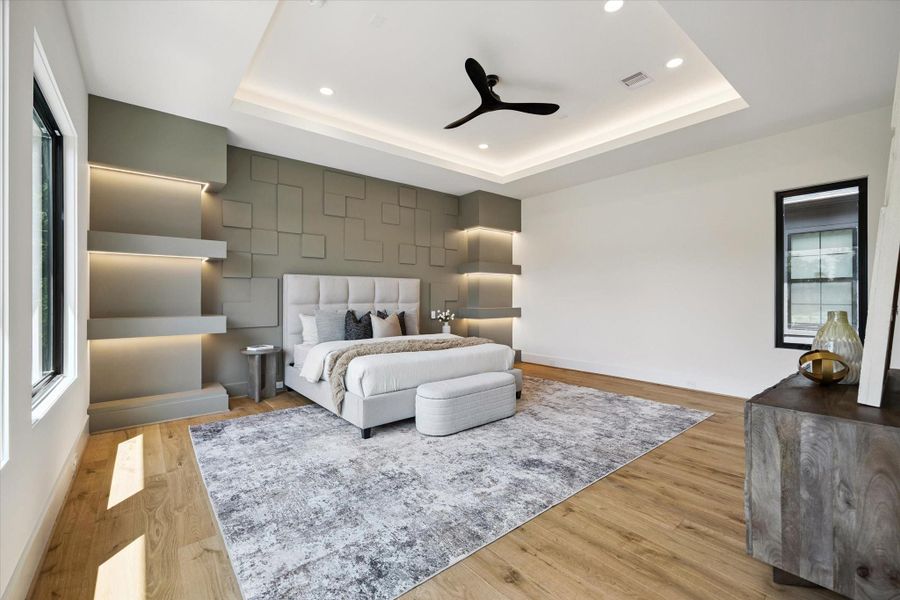 This luxurious primary suite features an accent designer wall with symmetrical shelves on both sides, and tray ceiling adding a tasteful touch of elegance and comfort. This luxurious primary suite features an accent designer wall with symmetrical shelves on both sides, and tray ceiling adding a tasteful touch of elegance and comfort.