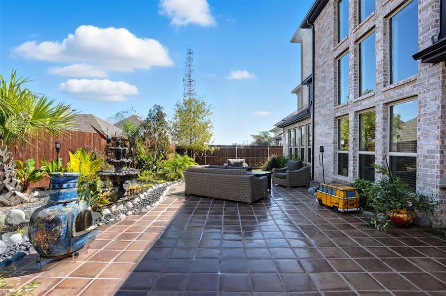Fenced backyard featuring an outdoor living space and a patio area Fenced backyard featuring an outdoor living space and a patio area