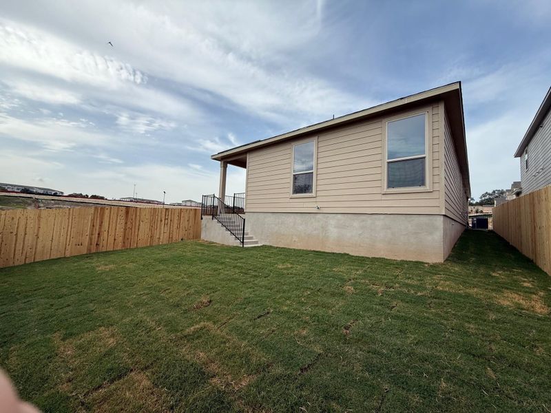 Front exterior of a new home in Creekside at Estancia, Austin, TX, highlighting curb appeal (Image 2).