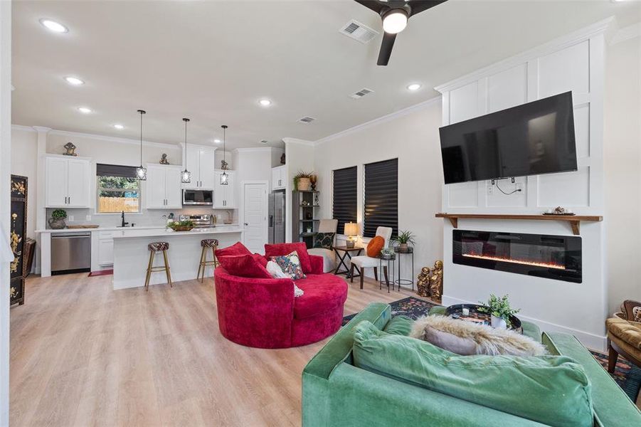 Living room featuring fireplace and ceiling fan