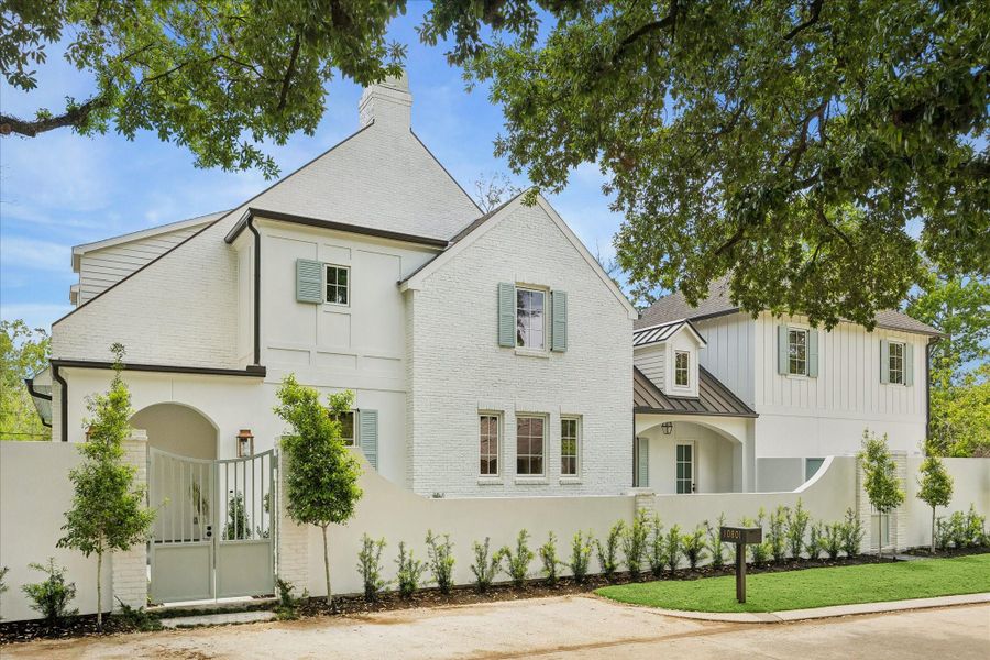 Exterior with gated courtyard entry, ravine location with manicured landscaping, mature trees, turf and pool creating a private, estate-style setting. Timeless architecture highlighted by shutters, arched openings & refined exterior finishes. We love this extra parking space that was created in the front of the home!