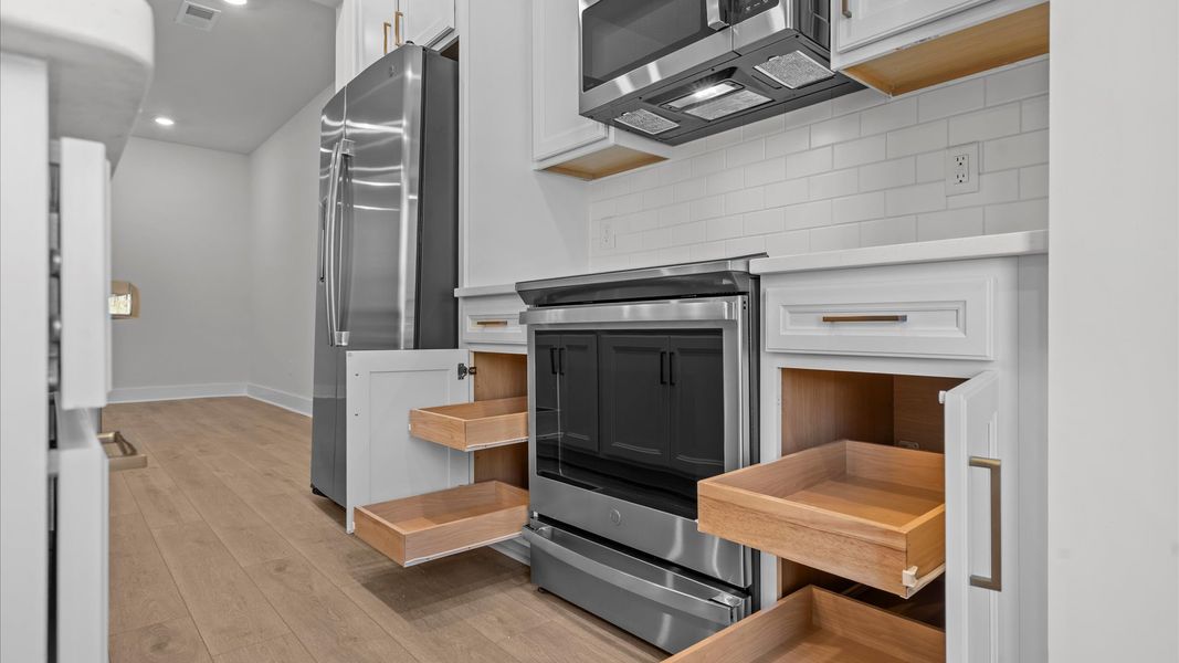 Superior kitchen with quartz countertops, pendant lighting, and plenty of storage space located in Simpsonville, SC