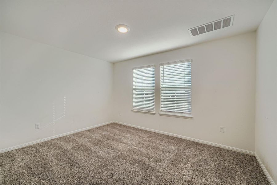 Carpeted spare room with baseboards