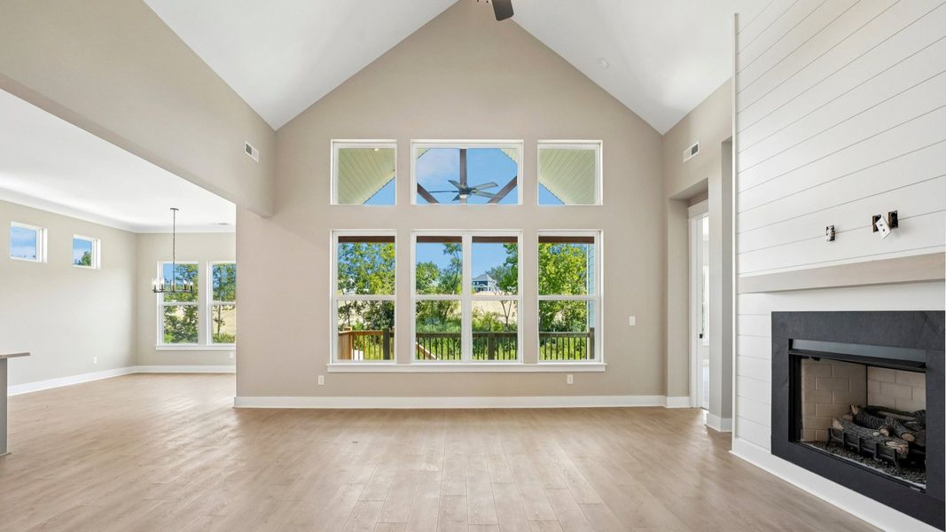 Elevated living space with various windows and fireplace