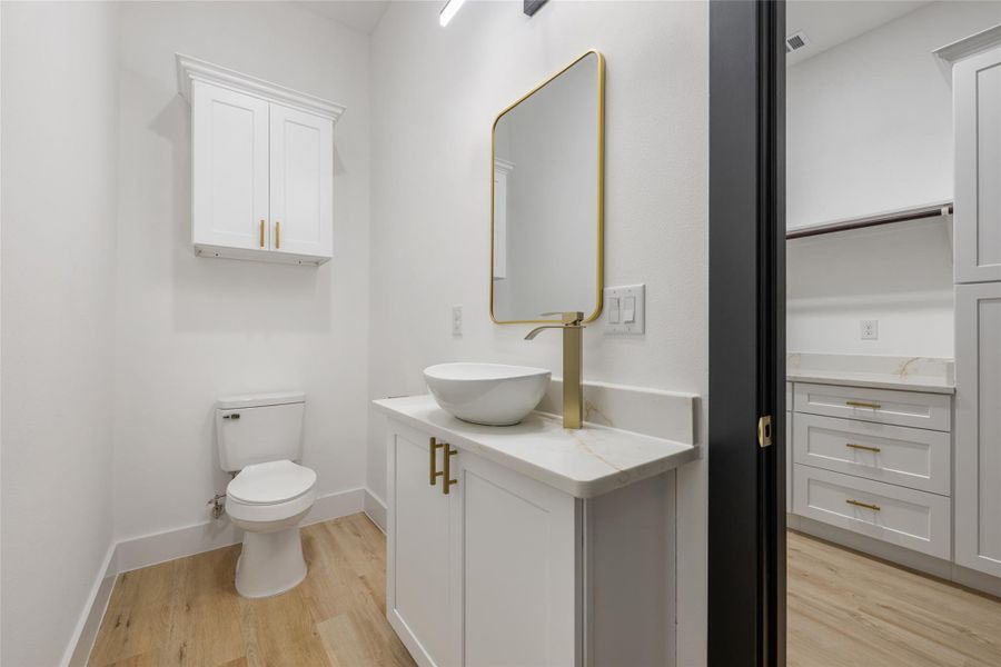 Bathroom featuring light wood-style flooring and vanity Bathroom featuring light wood-style flooring and vanity