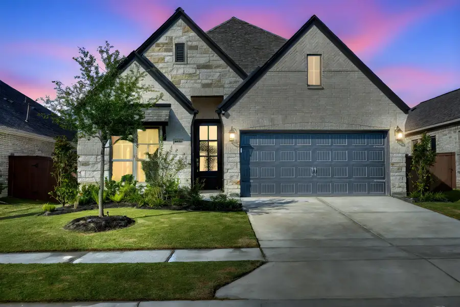 Front exterior of a new home in Meridiana 40'/45', Manvel, TX, highlighting curb appeal (Image 2).