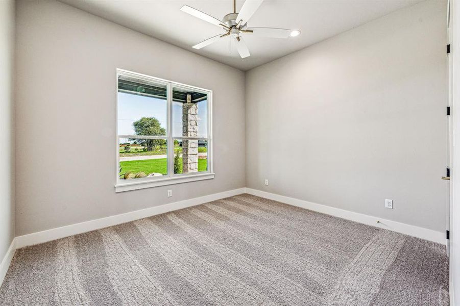 Unfurnished room featuring carpet flooring and ceiling fan