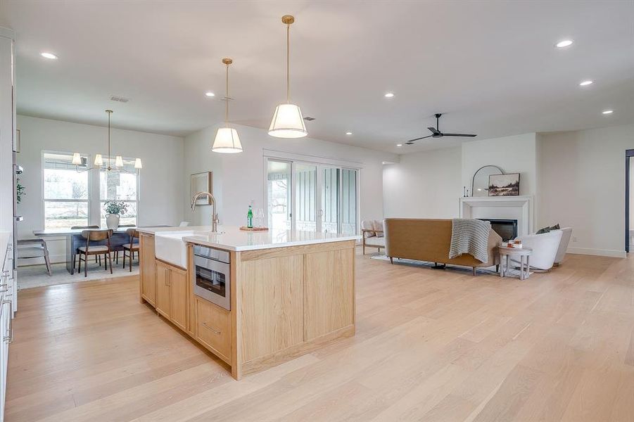 Kitchen with stain grade white oak island, panel ready dishwasher and in island microwave