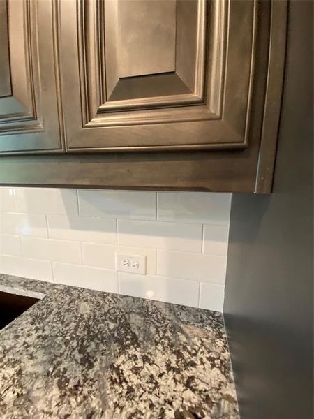 Maple Slate grey cabinets, white subway backsplash & beautiful Bianco Antico granite countertops