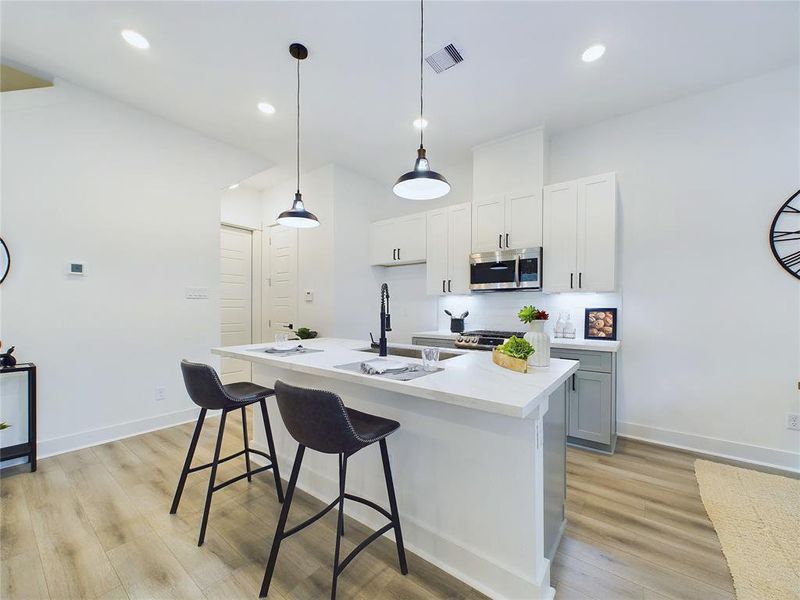 Gorgeous kitchen island with extra seating area. Model home photos, finishes and floor plan MAY VARY!