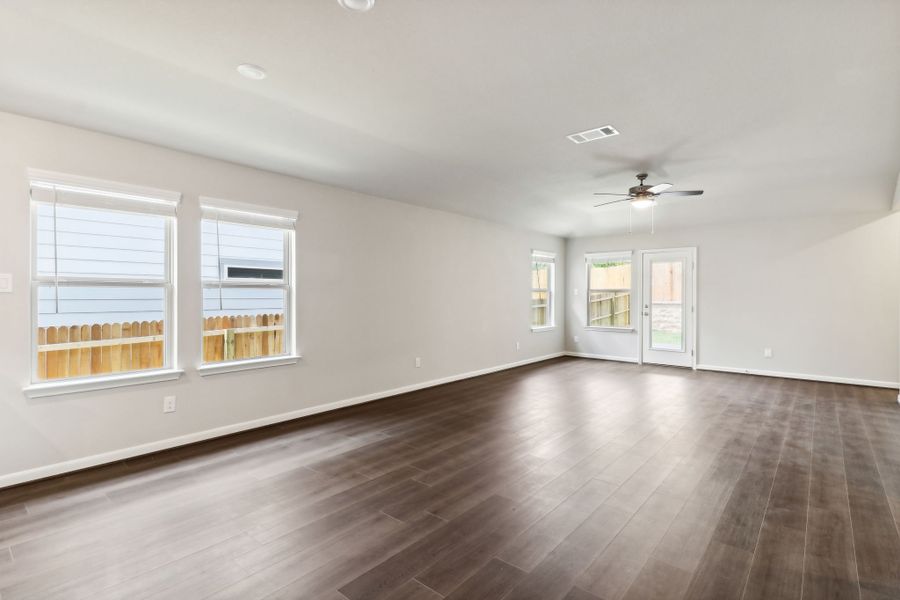 Dining room and living room in the Hughes floorplan at a Meritage Homes community.