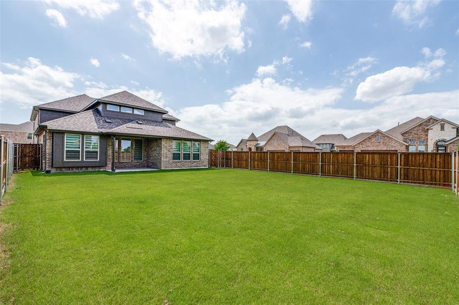 Rear view of property with a shingled roof