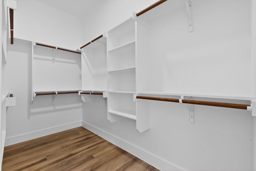 Ample hanging space and shelving offer exceptional organization within this walk-in closet.