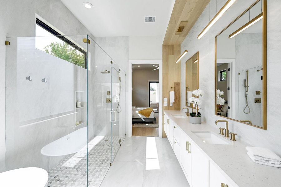 Ensuite bathroom with healthy amount of natural light, double vanity, a marble finish shower, a soaking tub, and recessed lighting