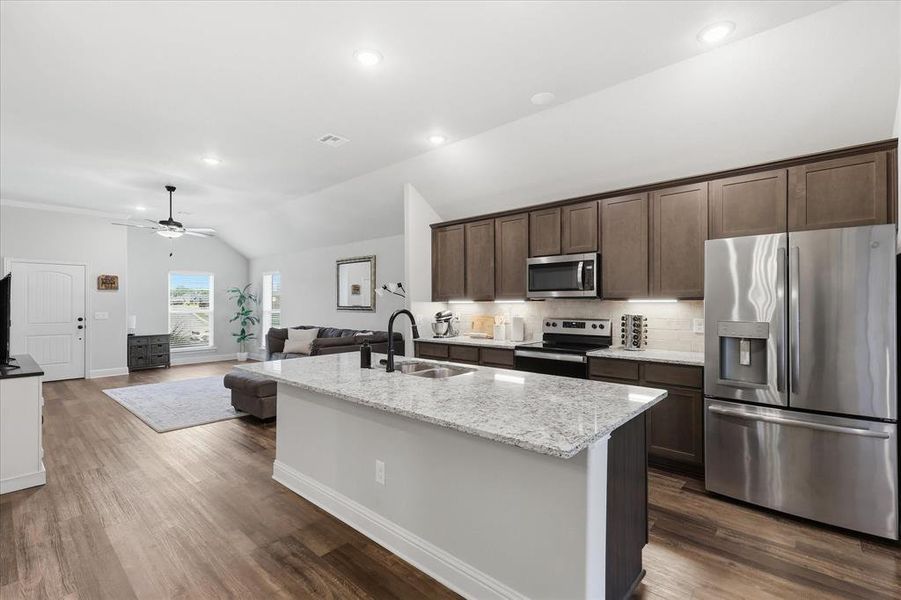 Spacious island kitchen located adjacent to the living room, offering an open layout ideal for cooking, gathering, and entertaining.