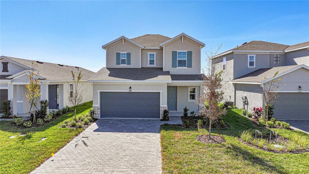 Front exterior of a new home in , Punta Gorda, FL, highlighting curb appeal (Image 1).