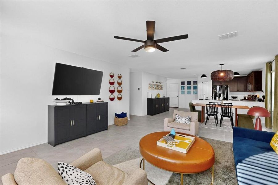 Living room with light tile patterned floors and ceiling fan Living room with light tile patterned floors and ceiling fan