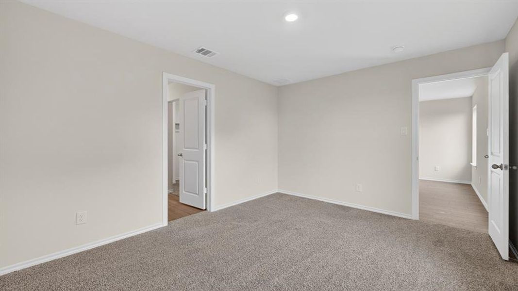Carpeted room featuring light gray walls, recessed lighting, and white trim