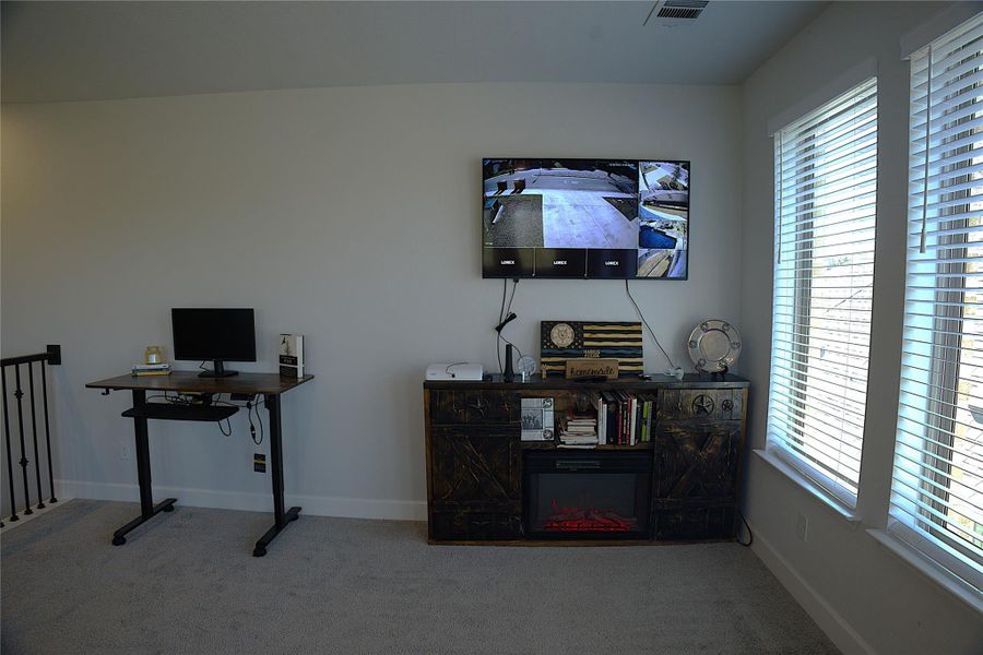 Carpeted office space featuring baseboards Carpeted office space featuring baseboards