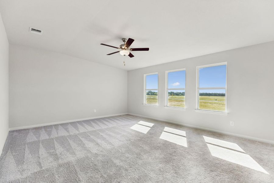 Generous windows, carpeted bedroom.