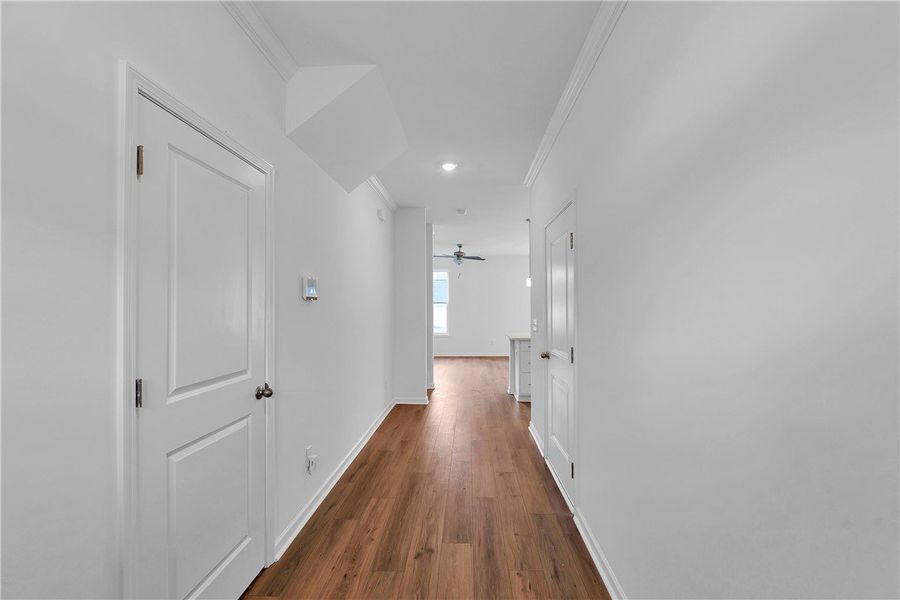 This spacious hallway features rich hardwood floor