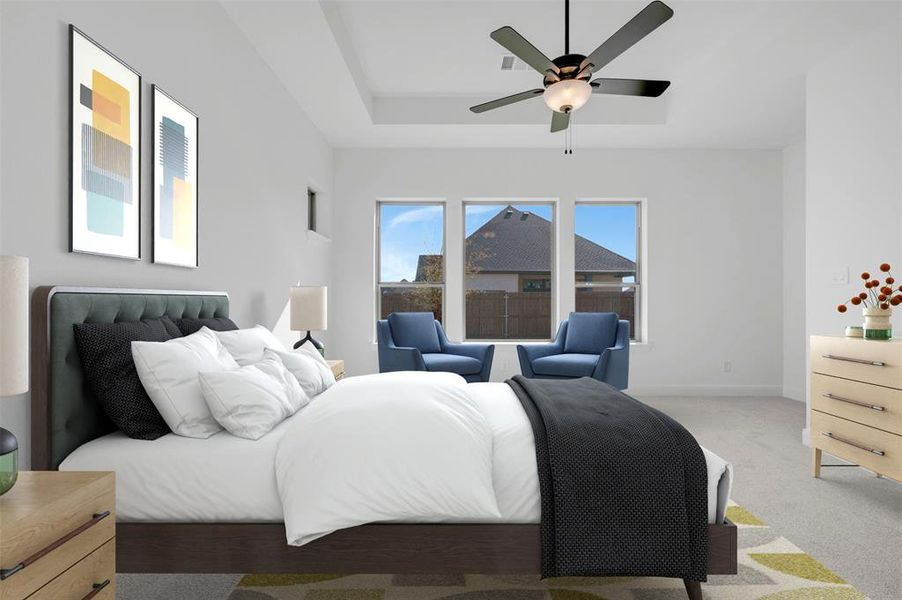 Spacious room featuring a tray ceiling, ceiling fan with integrated lighting, and three large windows Spacious room featuring a tray ceiling, ceiling fan with integrated lighting, and three large windows