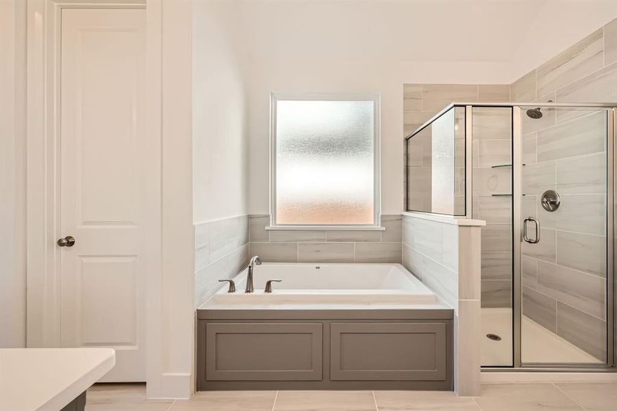 Bathroom featuring tile patterned floors and separate shower and tub