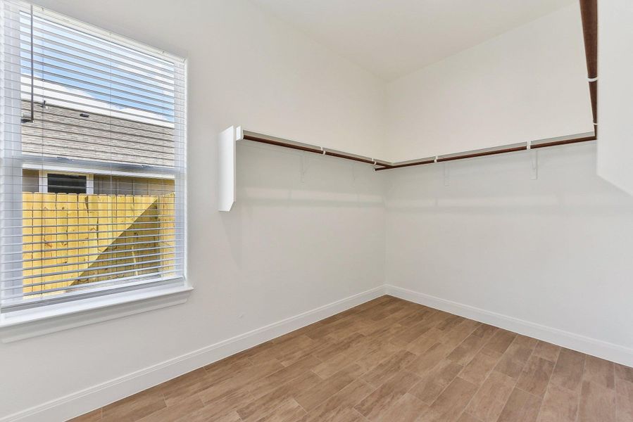 Walk in closet with wood finished floors Walk in closet with wood finished floors