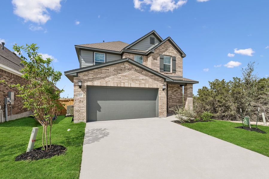 Front exterior of a new home in Mayfair - Select Garden Series, New Braunfels, TX, highlighting curb appeal (Image 2). Front exterior of a new home in Mayfair - Select Garden Series, New Braunfels, TX, highlighting curb appeal (Image 2).