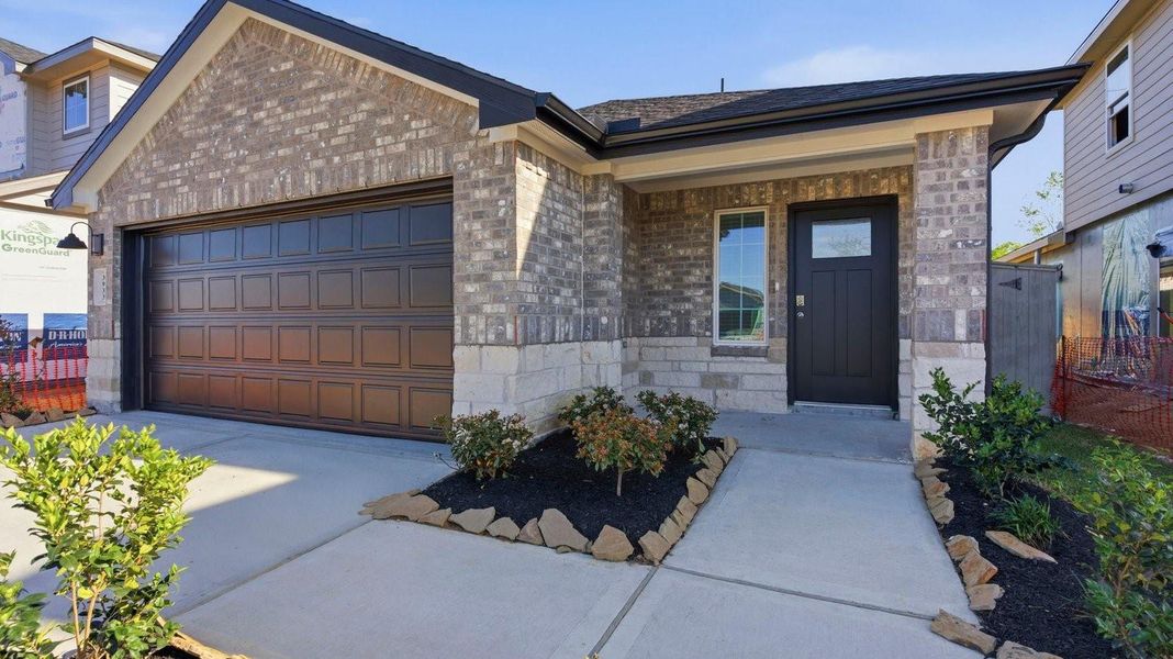 A view of the home with the front entry and the garage