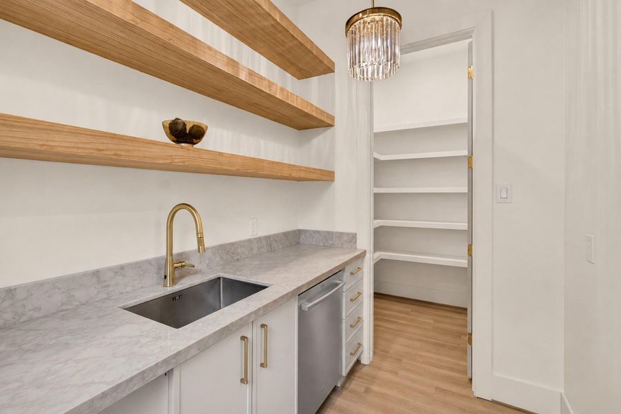 The spacious butler's pantry offers additional storage, prep space, and seamless convenience when entertaining guests. The spacious butler's pantry offers additional storage, prep space, and seamless convenience when entertaining guests.