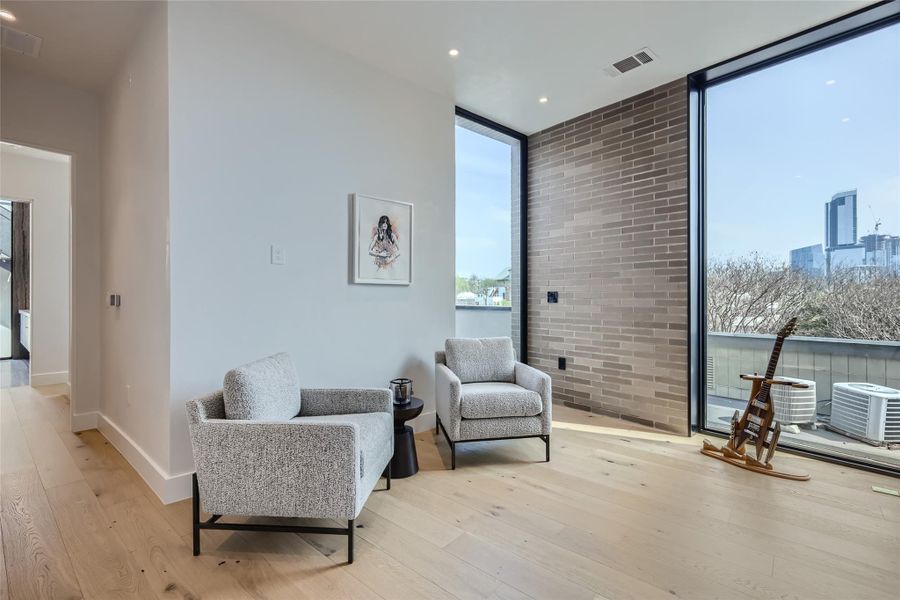 Sun-filled interior space with extensive glass offers urban skyline views. Sun-filled interior space with extensive glass offers urban skyline views.