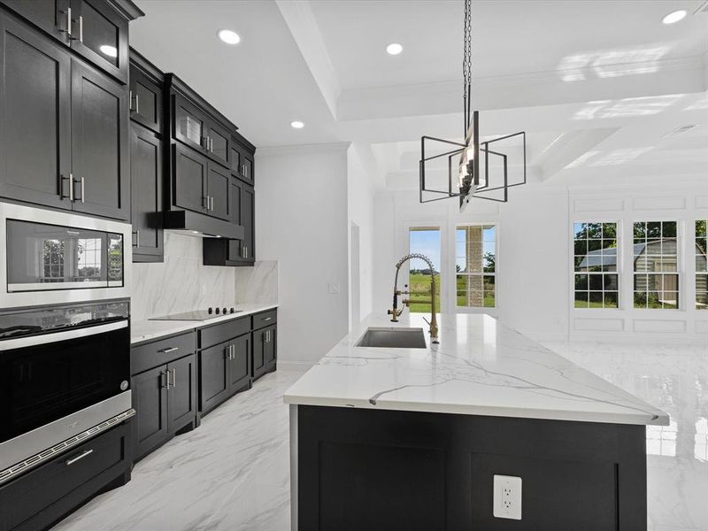 Kitchen featuring oven, a sink, built in microwave, recessed lighting, and backsplash