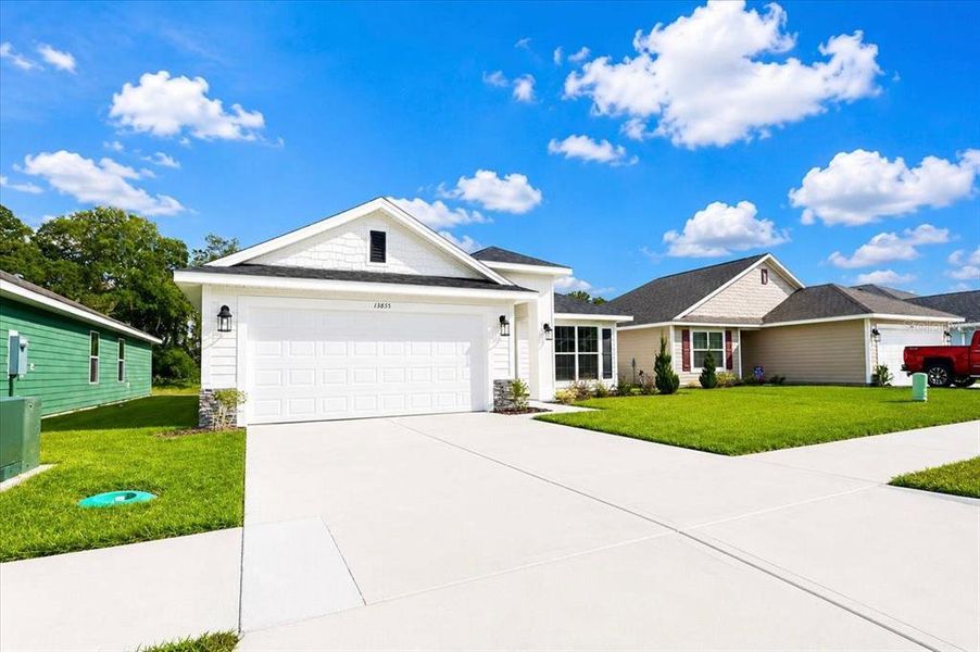 Front exterior of a new home in Country Way South, Newberry, FL, highlighting curb appeal (Image 26).