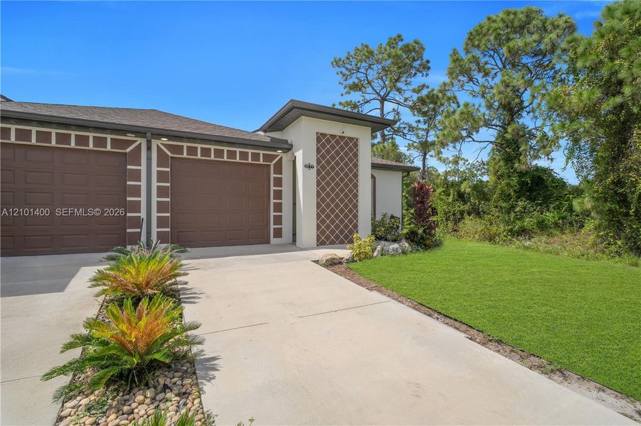 Front exterior of a new home in , Lehigh Acres, FL, highlighting curb appeal (Image 5).