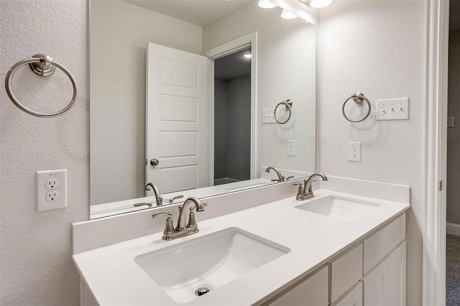 Full bath featuring a sink and double vanity