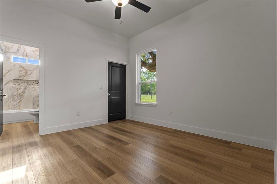 Unfurnished room with wood finished floors and ceiling fan