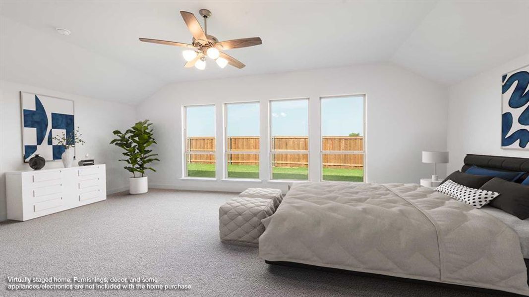 Carpeted bedroom with vaulted ceiling and ceiling fan