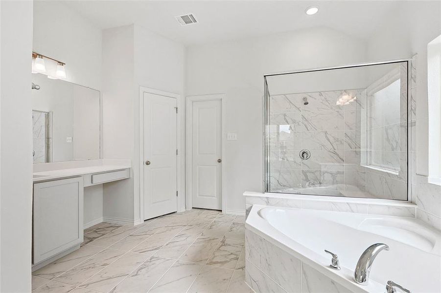 Bathroom featuring lofted ceiling, vanity, tile floors, and plus walk in shower