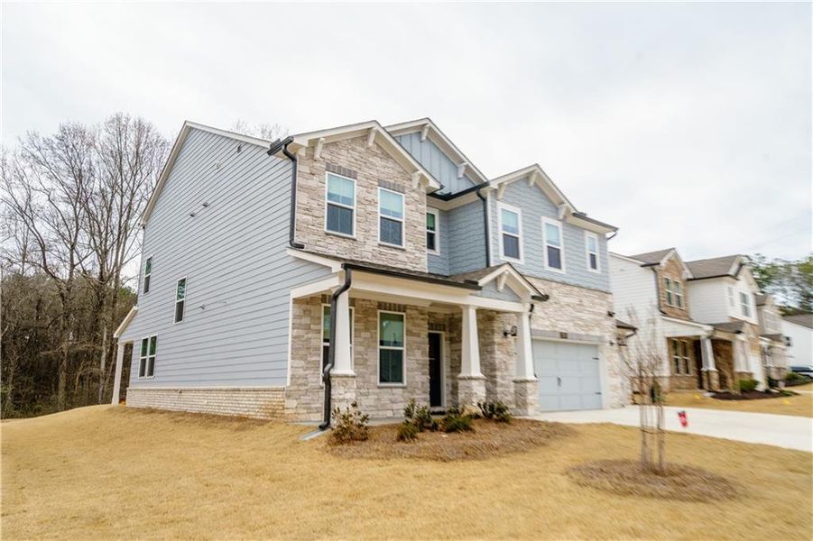 Front exterior of a new home in , Powder Springs, GA, highlighting curb appeal (Image 35). Front exterior of a new home in , Powder Springs, GA, highlighting curb appeal (Image 35).