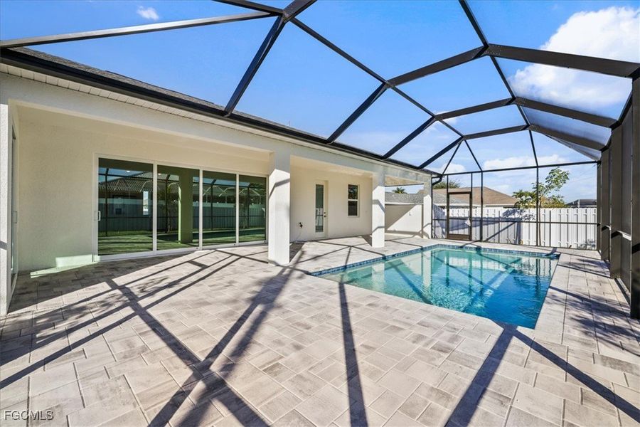 Swimming pool with a sunroom, a patio, and a lanai