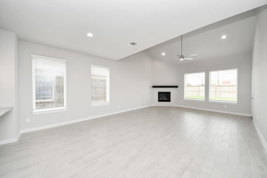 Make memories gathered around the table with your family and friends! This spacious dining room features elegant flooring, custom paint, and adjacent to family room and kitchen for open concept feel. Sample photo of completed home with similar floor plan. Actual colors and selections may vary.